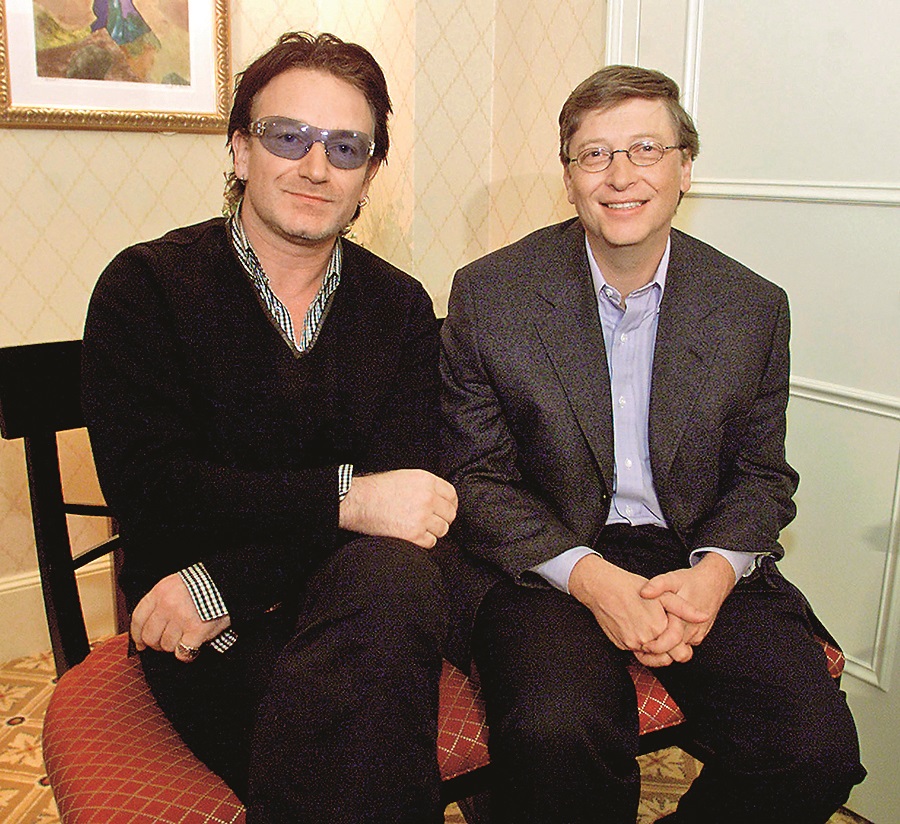 Bono (L), lead singer of the rock group U2, and Microsoft chairman Bill Gates sit together before a news conference at the World Economic Forum in New York, February 2, 2002. Gates teamed up with rock icon Bono in an appeal to world leaders to substantially increase funding for global health care. (Photo by Jeff Christensen/WireImage)